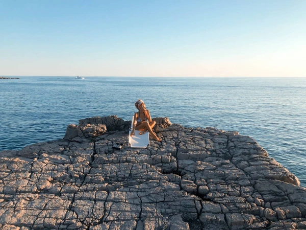 Woman relaxing on a hidden rocky beach along the Kotor coastline